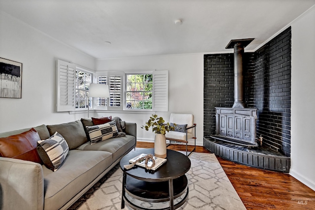 living room featuring wood-type flooring and a wood stove