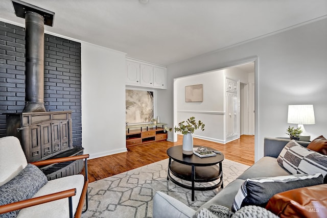 living room featuring light hardwood / wood-style flooring and a wood stove