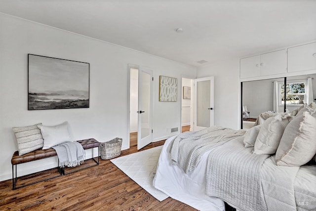 bedroom with hardwood / wood-style flooring and a closet