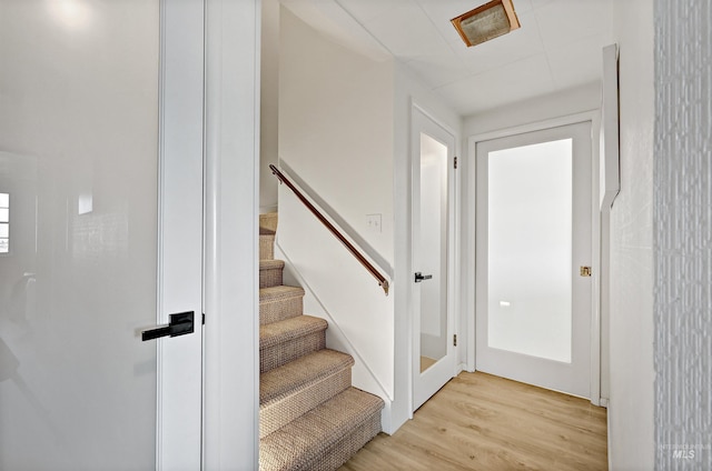 stairway with hardwood / wood-style flooring