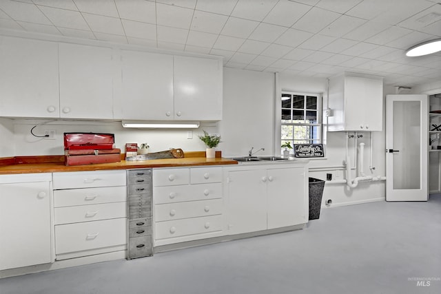 kitchen with white cabinetry and sink