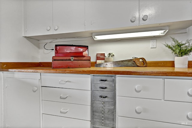 kitchen with white cabinetry and butcher block counters