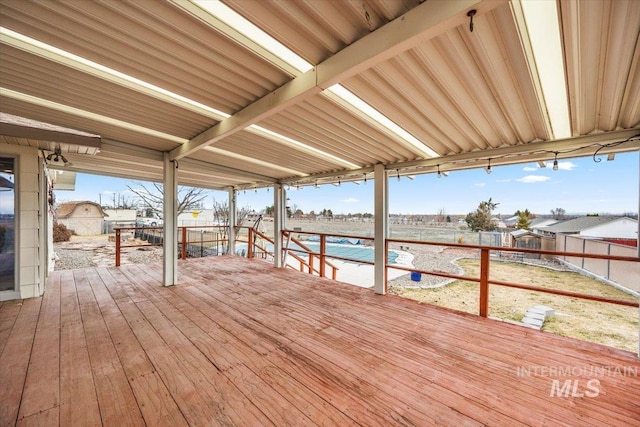 wooden terrace with a fenced backyard