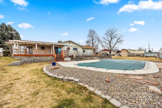 view of swimming pool with a fenced in pool, a yard, fence, and a wooden deck