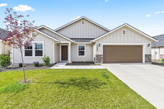 10255 W Gladiola St, Star, ID 83669 - view of front of house featuring a garage, board and batten siding, driveway, and a front lawn