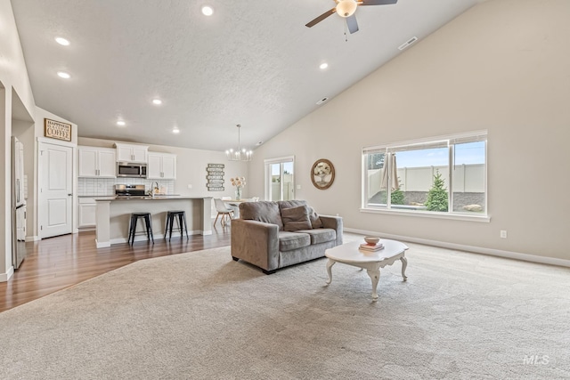 10255 W Gladiola St, Star, ID 83669 - living room with light carpet, recessed lighting, a chandelier, a ceiling fan, and a textured ceiling