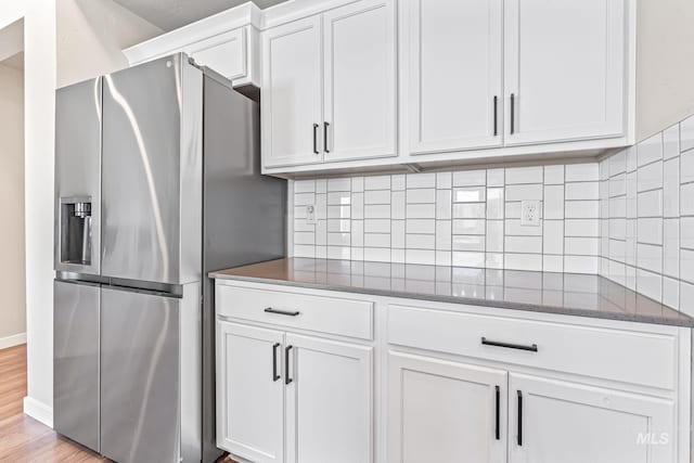 10255 W Gladiola St, Star, ID 83669 - kitchen with stainless steel fridge with ice dispenser, white cabinets, tasteful backsplash, and dark stone countertops