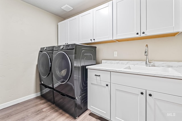10255 W Gladiola St, Star, ID 83669 - laundry room with cabinet space, washer and clothes dryer, and light wood-type flooring
