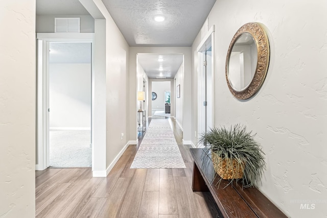 10255 W Gladiola St, Star, ID 83669 - corridor featuring wood finished floors and a textured ceiling