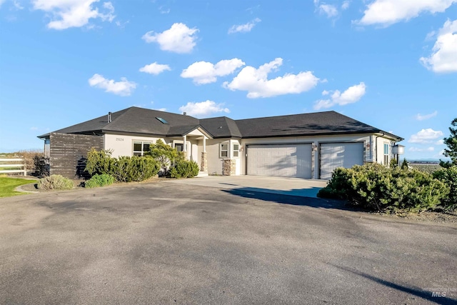 single story home featuring an attached garage and concrete driveway