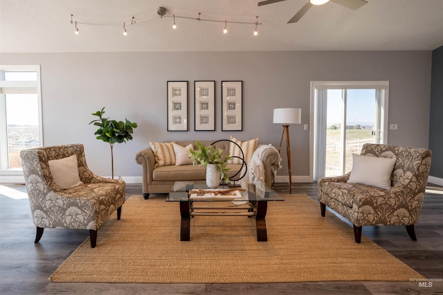 living room featuring a ceiling fan, wood finished floors, and baseboards