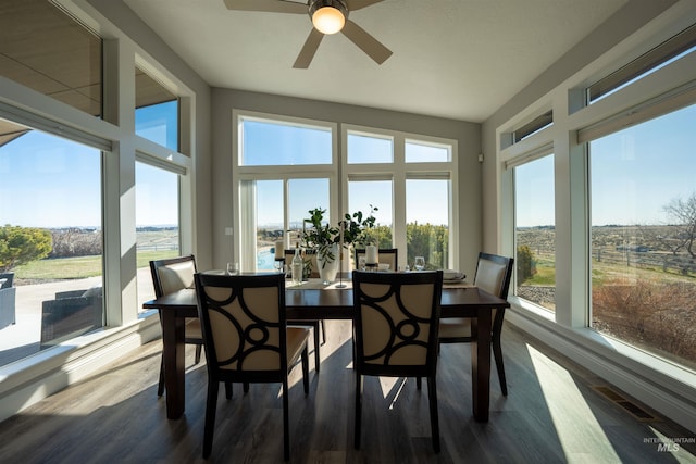 sunroom with a ceiling fan and visible vents