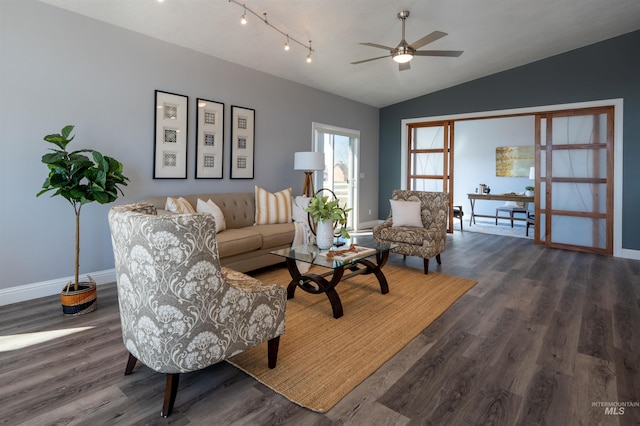 living area with a ceiling fan, lofted ceiling, wood finished floors, and baseboards