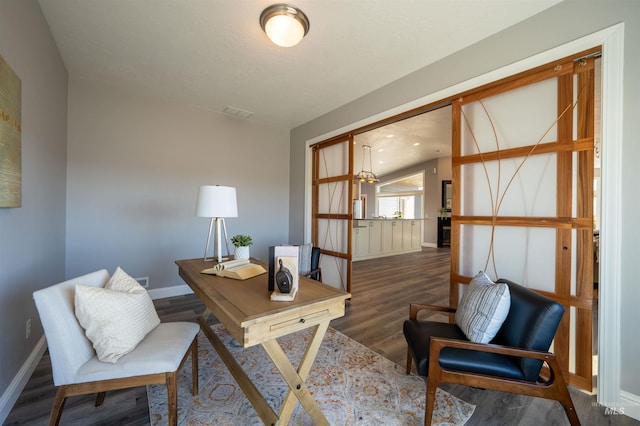 office space featuring baseboards and wood finished floors