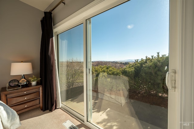 carpeted bedroom featuring access to exterior and visible vents