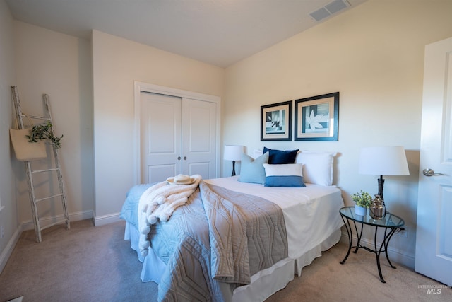 carpeted bedroom with visible vents, baseboards, and a closet