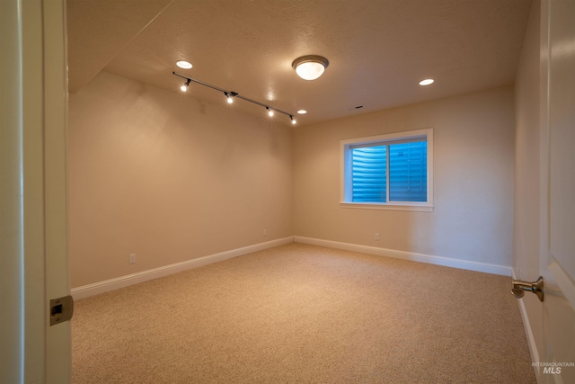 carpeted spare room with recessed lighting, visible vents, baseboards, and a textured ceiling