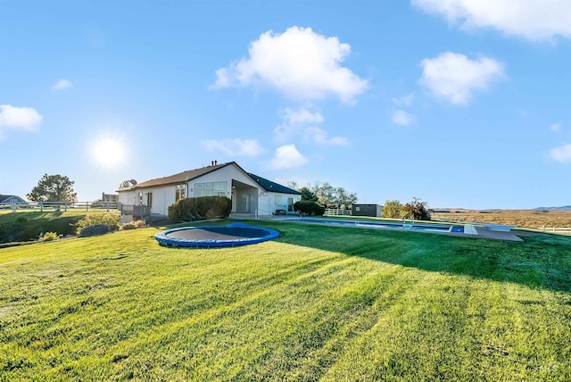 view of yard featuring a pool and fence