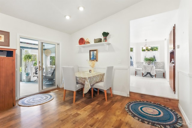 dining space with recessed lighting, a wealth of natural light, and wood finished floors