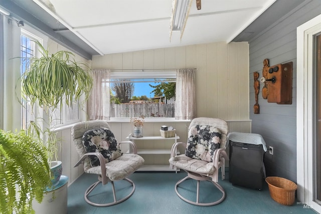 sitting room featuring wood walls