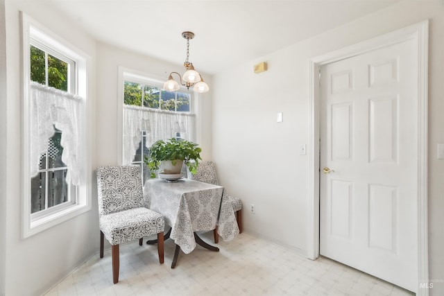 dining area with a notable chandelier and light floors