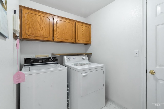 laundry room with cabinet space and washing machine and dryer