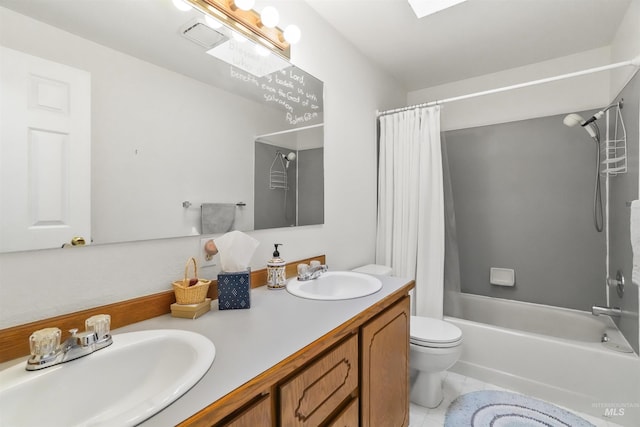 full bathroom with toilet, tile patterned floors, a sink, and shower / tub combo with curtain
