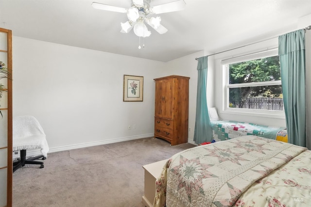 bedroom featuring baseboards, carpet flooring, and a ceiling fan