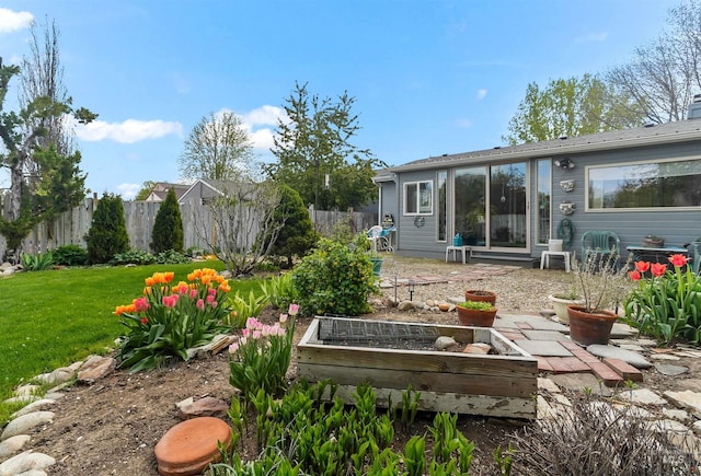view of yard with a garden and fence
