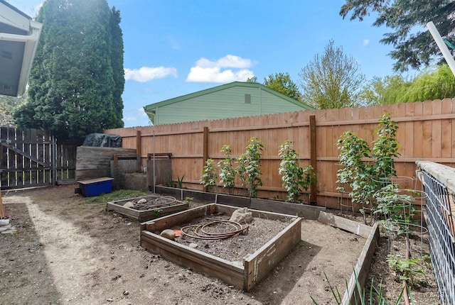 view of yard with a fenced backyard and a garden