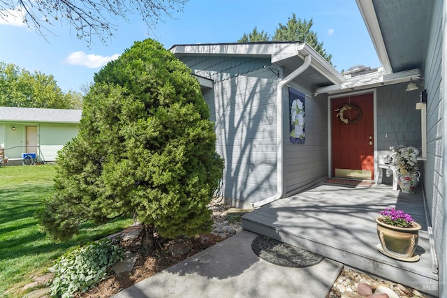 entrance to property with a lawn