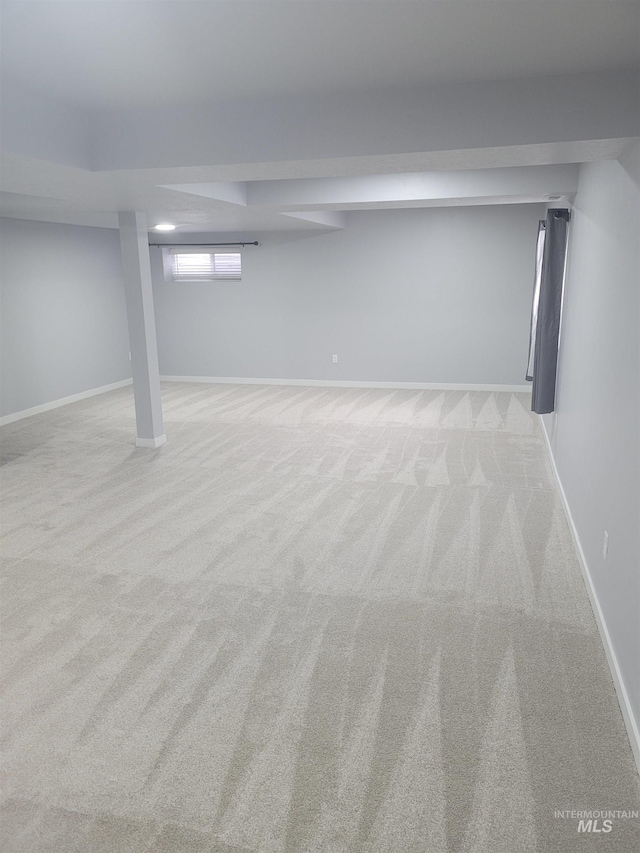 basement featuring light carpet