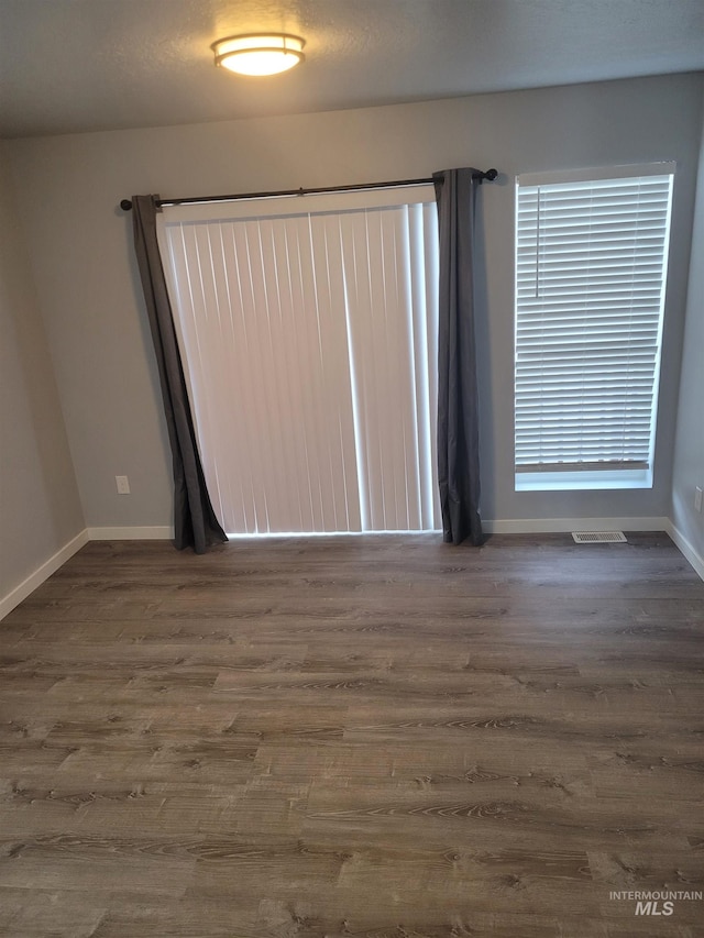 unfurnished room featuring hardwood / wood-style flooring