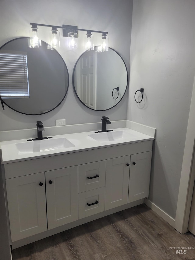 bathroom featuring hardwood / wood-style floors and double sink vanity