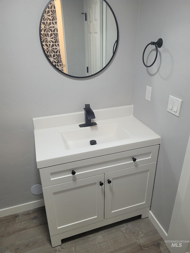 bathroom with hardwood / wood-style floors and vanity