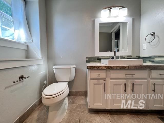 bathroom featuring tile patterned floors, vanity, and toilet