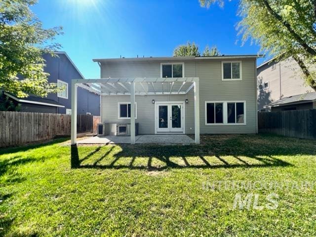 back of property with a lawn, central AC, a pergola, and french doors