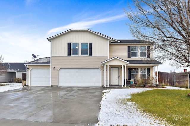 front facade with a garage and a lawn