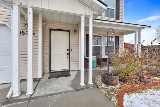 view of exterior entry featuring covered porch