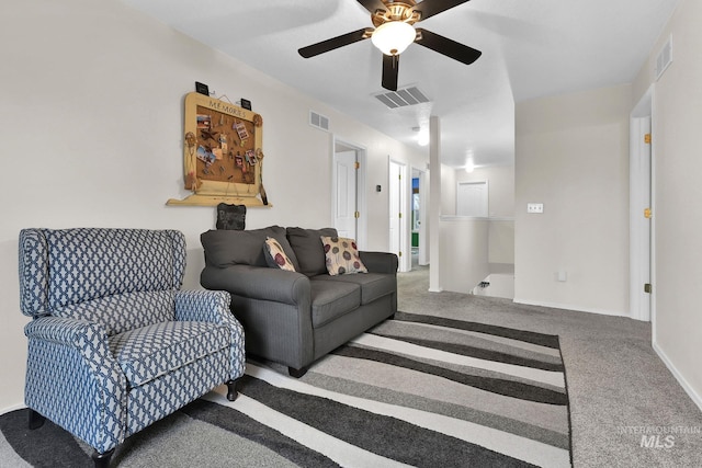 carpeted living room with ceiling fan