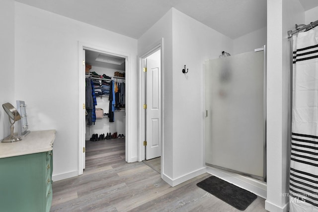 bathroom featuring hardwood / wood-style floors and walk in shower