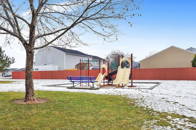 snow covered playground featuring a yard