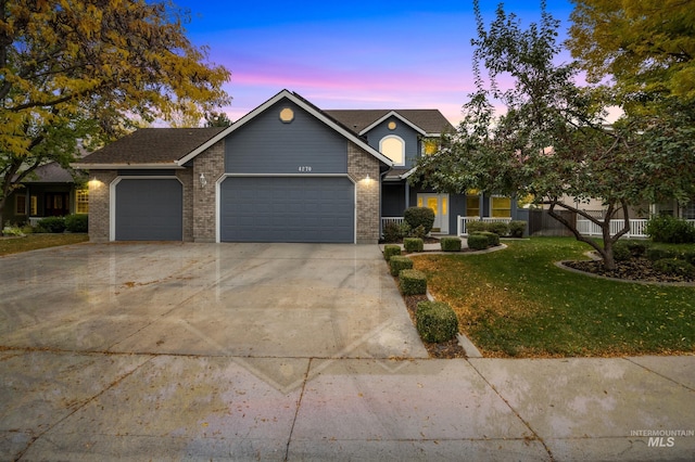 view of front of property featuring a yard and a garage