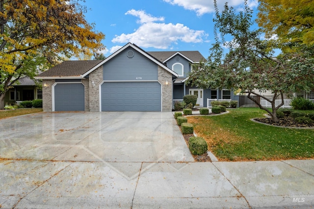 view of front of home with a front yard and a garage