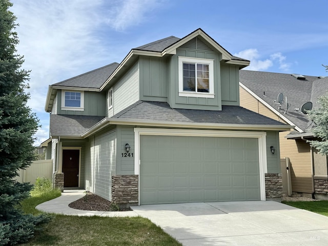 1241 W Ann Taylor St, Meridian, ID 83646 - view of front of house with stone siding, board and batten siding, driveway, a garage, and fence