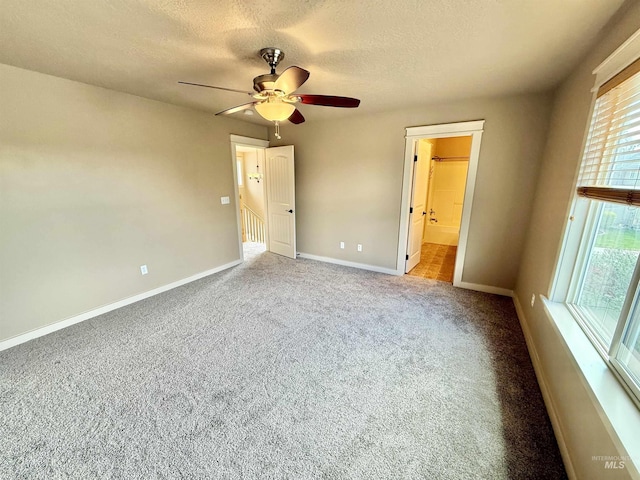 1241 W Ann Taylor St, Meridian, ID 83646 - unfurnished bedroom with a textured ceiling, baseboards, carpet floors, ceiling fan, and connected bathroom