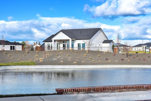 rear view of property featuring a water view