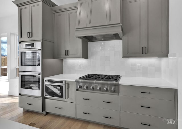 11321 S Yeoman St, Kuna, ID 83634 - kitchen with appliances with stainless steel finishes, gray cabinets, light countertops, and light wood-style flooring