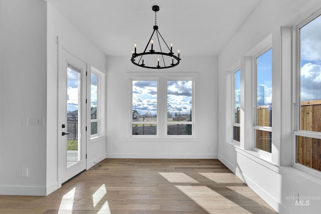 unfurnished sunroom with a notable chandelier