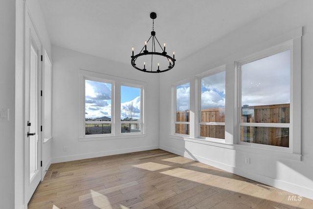 unfurnished sunroom featuring an inviting chandelier